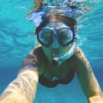 woman wearing water goggles underwater